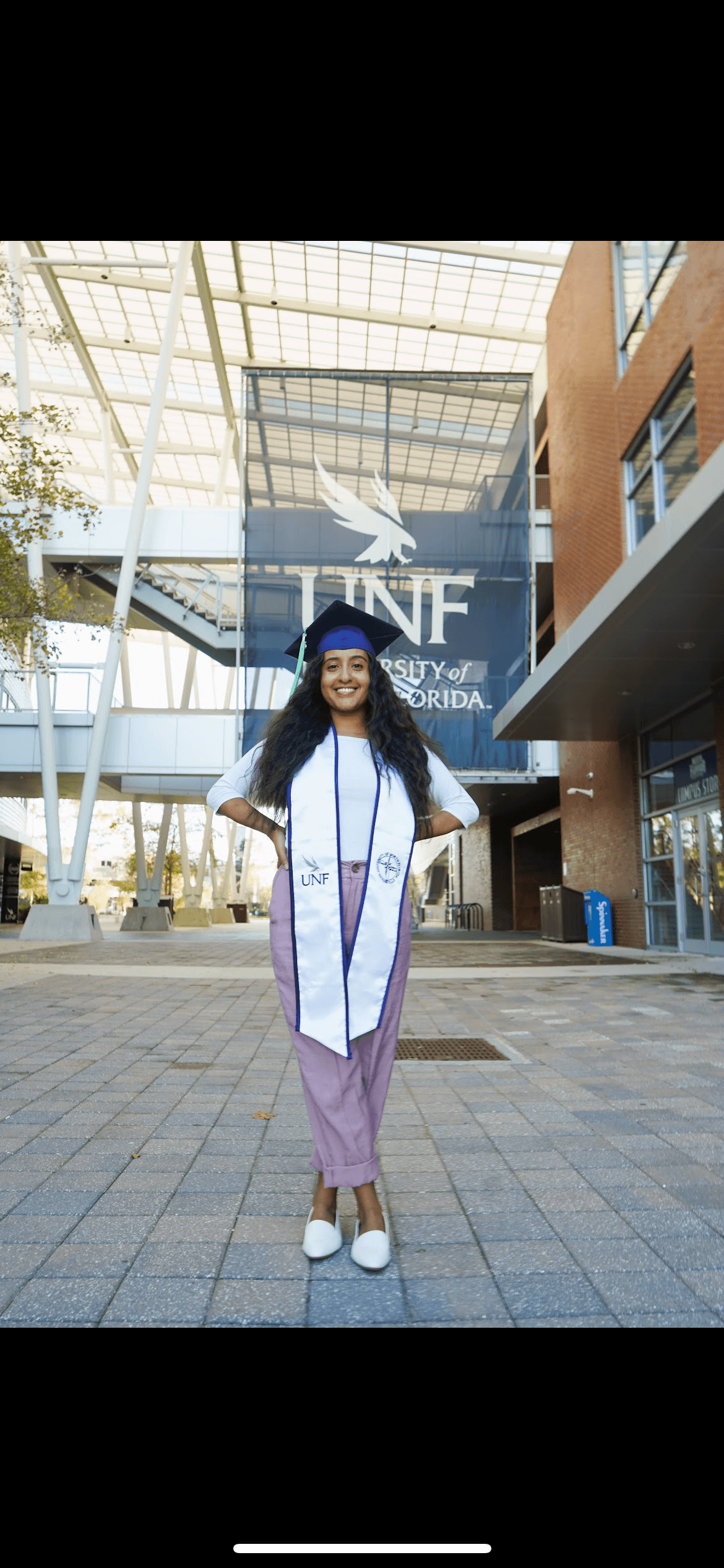 Hannah Ghidey, certified birth doula in Jacksonville FL, smiling in graduation portrait
